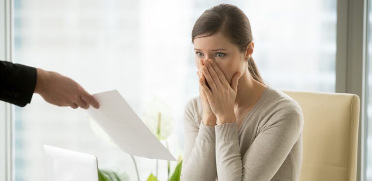 Employer giving dismissal notice to young woman